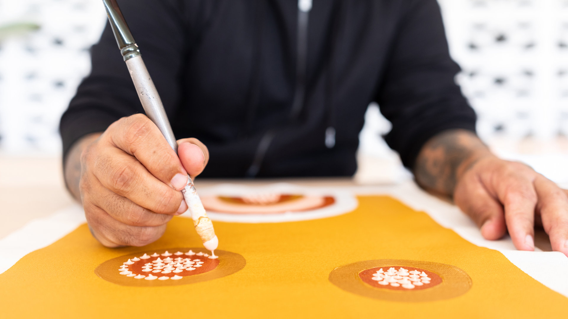 Indigenous Artist Painting Artwork In Studio